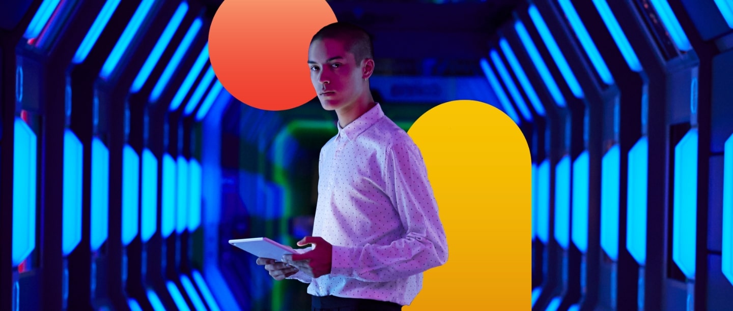 man holding laptop in cybersecurity background with colour blocks around him